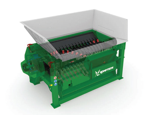 Green industrial shredder with an open hopper and visible internal cutting components.